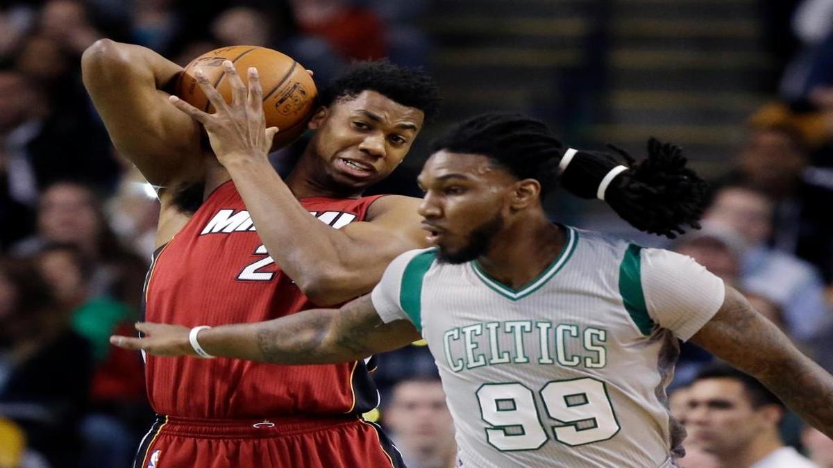 Miami Heat center Hassan Whiteside pulls down a defensive rebound in front of Boston Celtics forward Jae Crowder (99) in the first quarter of an NBA basketball game on April 13, 2016, in Boston.