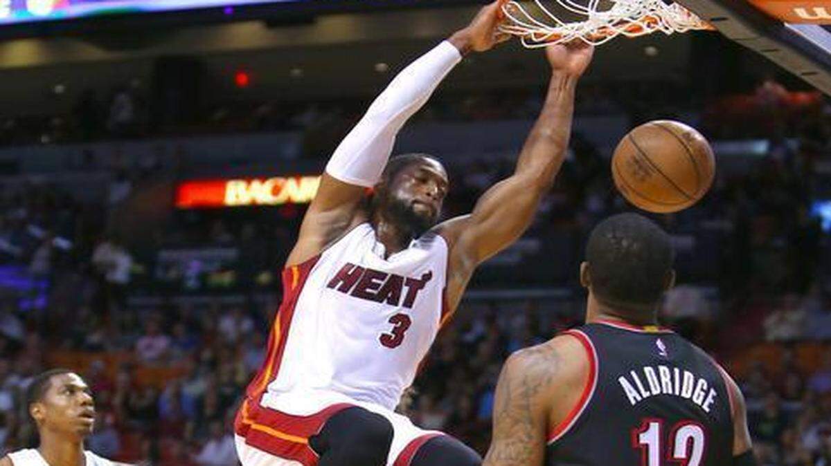 
Miami Heat guard Dwyane Wade dunks for two of his 32 points as Trail Blazers forward LaMarcus Aldridge looks on Wednesday, March 18, 2015 at AmericanAirlines Arena in Miami.
