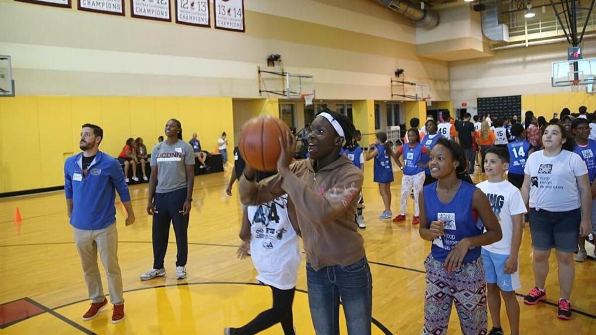 Kids and board members line up to take a shot at the basket during Camp Hoop Heroes at AmericanAirlines Arena in Miami on Wednesday, July 19, 2017, as part of the national program After-School All-Stars.
