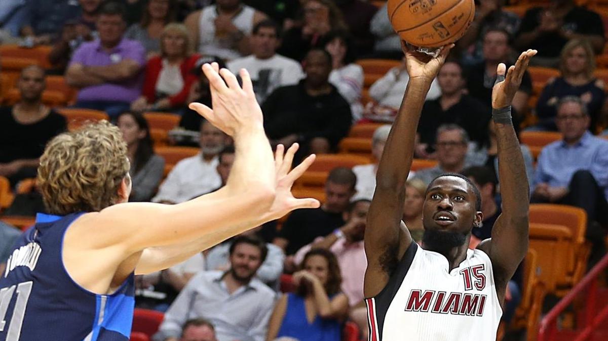 Miami Heat forward Okaro White, shoots to the basket against Mavericks' forward Dirk Nowitzki, in the second quarter of the Miami Heat vs Dallas Mavericks, NBA game at AmericanAirlines Arena in Miami on Thursday, January 19, 2017.