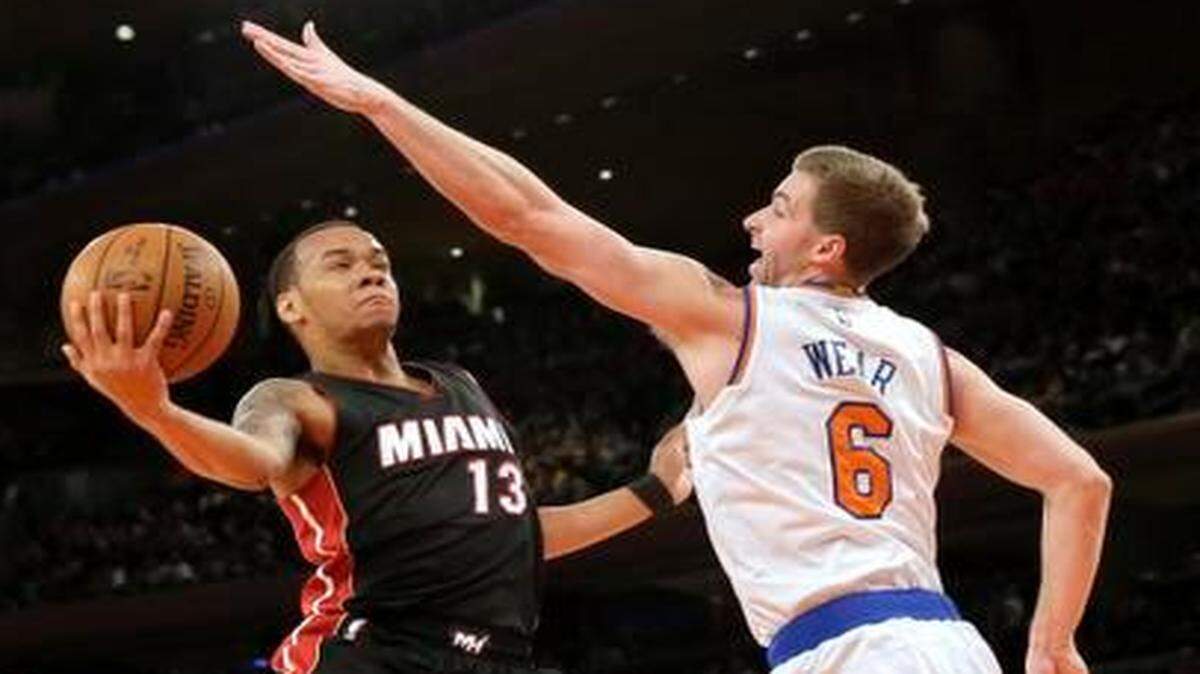 
Miami Heat guard Shabazz Napier (13) goes up against New York Knicks forward Travis Wear (6) during the first half Friday, Feb. 20, 2015, at Madison Square Garden in New York.
