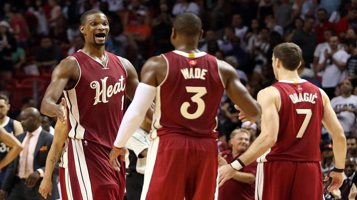 Chris Bosh, averaging 19.2 points, talks with Dwyane Wade and Goran Dragic during a game against the Pelicans. ‘He’s a great leader,’ Dragic said of Bosh. ‘He’s always teaching.’