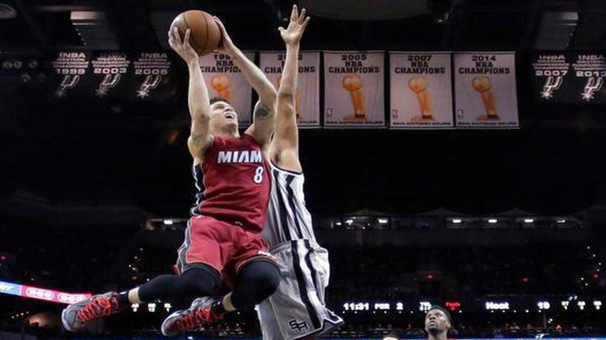 
Miami Heat’s Tyler Johnson (8) drives to the basket past San Antonio Spurs’ Boris Diaw during the first half of an NBA basketball game, Friday, Feb. 6, 2015, in San Antonio. 
