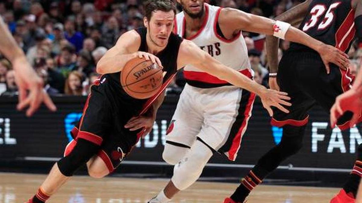 Miami Heat guard Goran Dragic, left, drives on Portland Trail Blazers guard Evan Turner during the first half of an NBA basketball game in Portland, Ore., Saturday, Dec. 3, 2016.