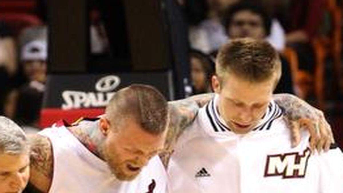 
Miami Heat center Chris Andersen is carried off the court by Justin Hamilton after sustaining an injury in the first quarter during a game against the Charlotte Hornets at the AmericanAirlines Arena on Sunday, Nov. 23, 2014.

