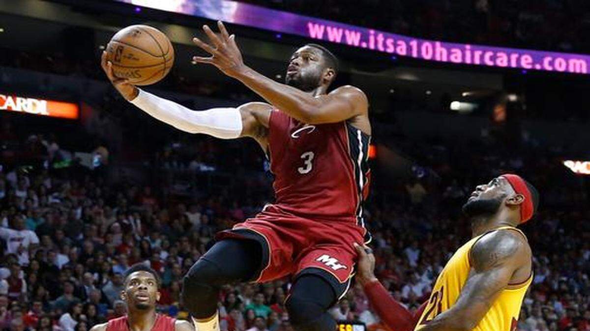 
Miami Heat guard Dwyane Wade goees for a layup over Cleveland Cavaliers forward LeBron James in the first quarter as the Miami Heat host the Cleveland Cavaliers at AmericanAirlines Arena on Thursday, December 25, 2014.
