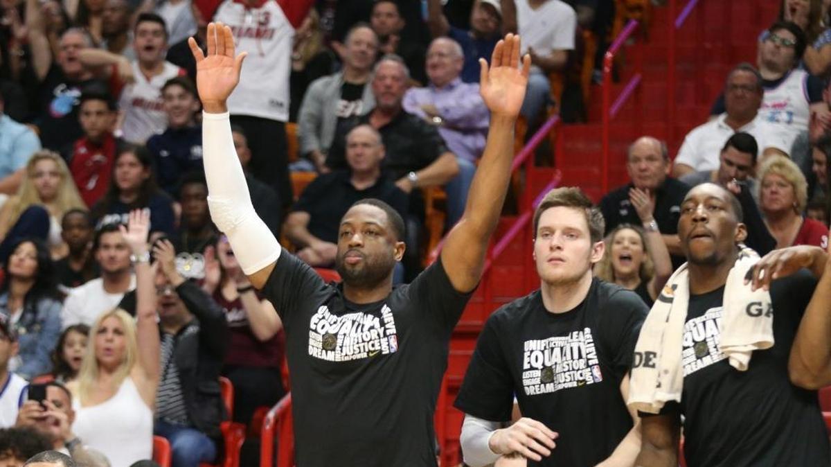 Miami Heat Dwyane Wade cheers from the bench in the first quarter after a Heat basket as they play the Milwaukee Bucks at the AmericanAirline Arena in Miami, Florida, February 9, 2018.