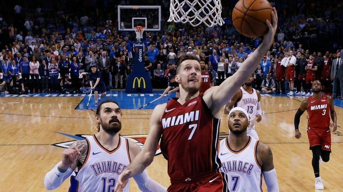 Miami Heat guard Goran Dragic goes up for a shot in front of Oklahoma City Thunder center Steven Adams (12) and forward Carmelo Anthony (7) during the second half of an NBA basketball game in Oklahoma City, Friday, March 23, 2018.