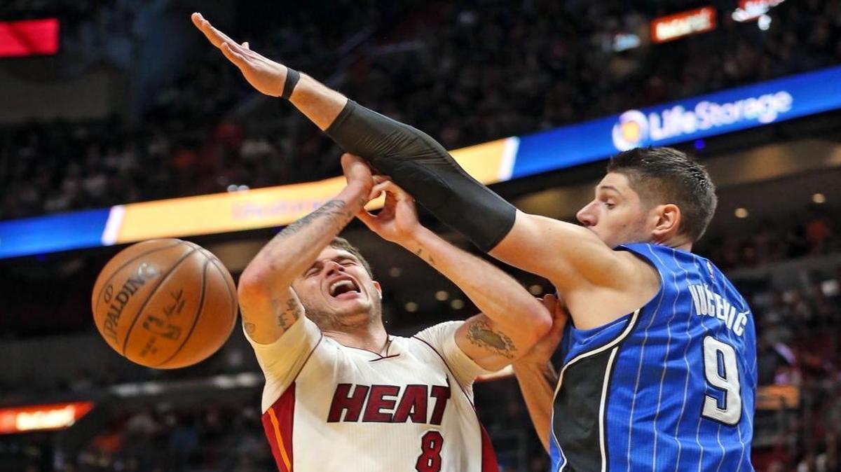 Miami Heat Tyler Johnson is blocked under the basket by Orlando Magic Nikola Vucevic in the second quarter at the AmericanAirlines Arena in Miami, Florida on Mon., Feb. 13, 2017.
