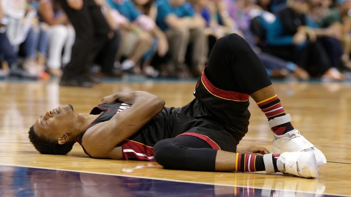Heat rookie Josh Richardson writhes in pain after injuring his left shoulder in Game 6 against the Hornets on Friday, April 30, 2016.