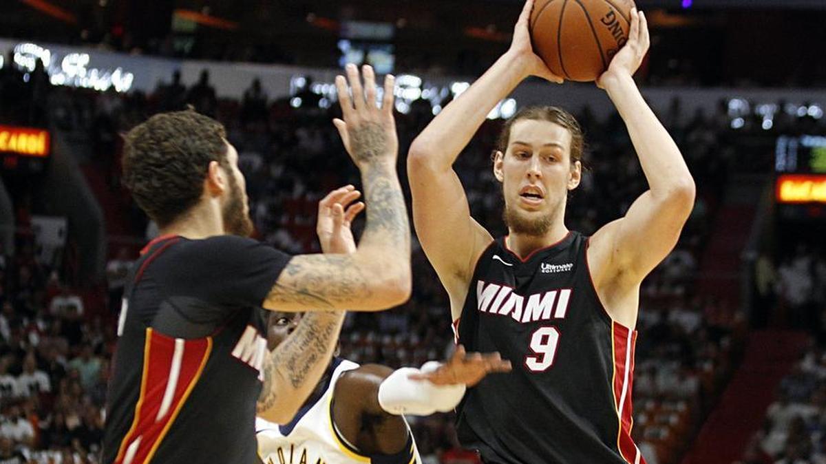 Miami Heat forward Kelly Olynyk gets ready to pass the ball to guard Tyler Johnson against the Pacers' Darren Collison in the first quarter of the Miami Heat vs Indiana Pacers game at AmericanAirlines Arena in Miami on Saturday, October 21, 2017.