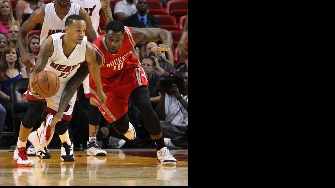 
Shabazz Napier fights for the ball with Tarik Black in the second quarter during a preseason game between the Miami Heat and Houston Rockets at AmericanAirlines Arena in Miami on Tuesday, October 21, 2014.

