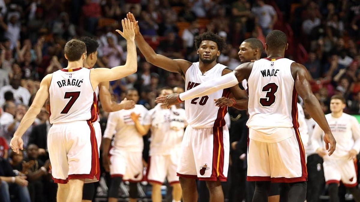 Dwyane Wade, Goran Dragic and Chirs Bosh of the Miami Heat, celebrate Justise Winslow's basket against the Philadelphia 76ERS, in the fourth quarter of a game at AmericanAirlines Arena in Miami on Saturday, November 21, 2015.