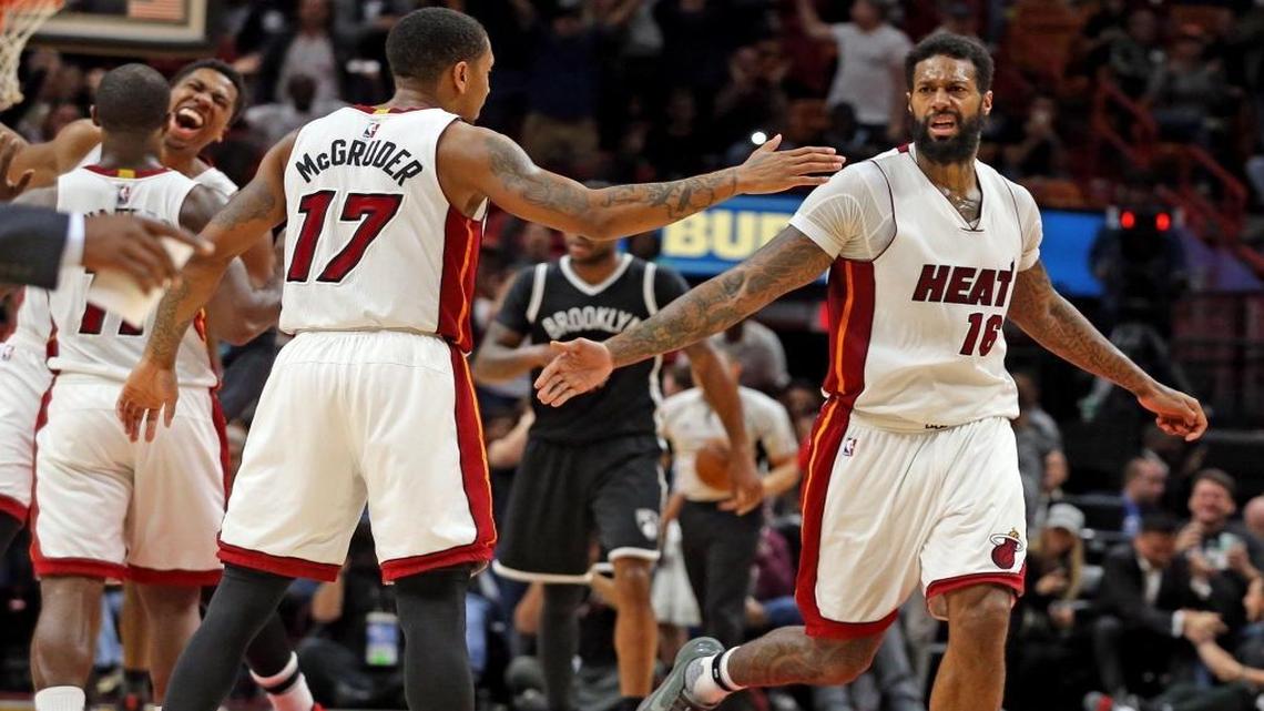 Miami Heat Rodney McGruder congratulates James Johnson afterJohnson's major dunk in the final seconds of the fourth quarter as they defeat the Brooklyn Nets at the AmericanAirlines Arena in Miami, Florida, Jan. 30, 2017.