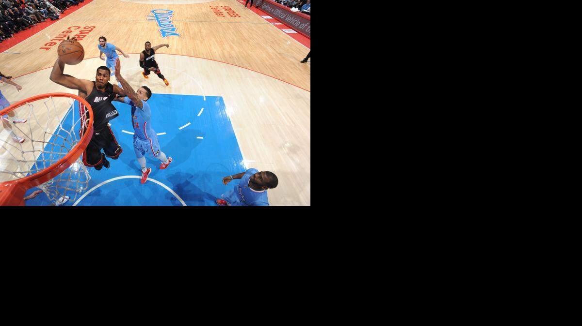 
 Hassan Whiteside #21 of the Miami Heat goes for the dunk against the Los Angeles Clippers during the game on January 11, 2015 at STAPLES CENTER in Los Angeles, California . 
