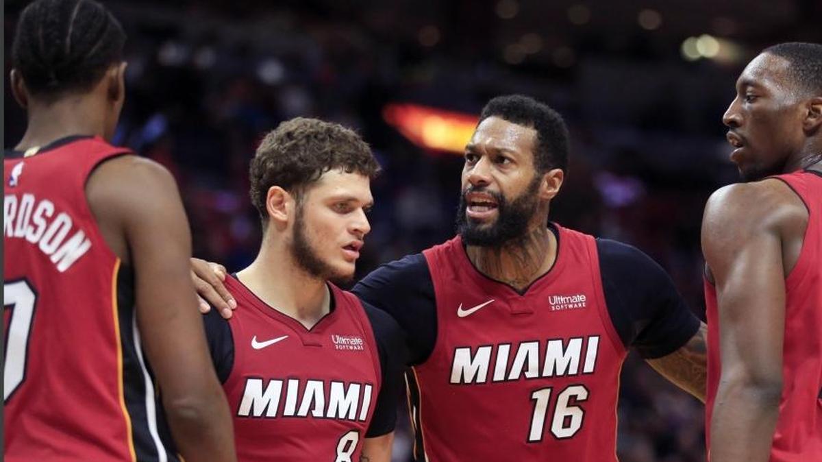 Miami Heat forward Josh Richardson, guard Tyler Johnson, forward James Johnson and center Bam Adebayo talk in overtime of the Heat’s win over the Knicks at AmericanAirlines Arena on Friday, January 5, 2018.