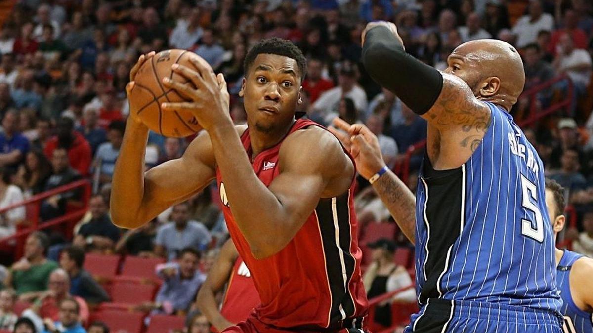 Miami Heat center Hassan Whiteside goes to the basket against Magic’s forward Marreese Speights on Dec. 26. During Whiteside’s prolonged absence, the Miami Heat tweaked its offense to have its frontcourt players handle the ball more. Whiteside said he loves it.
