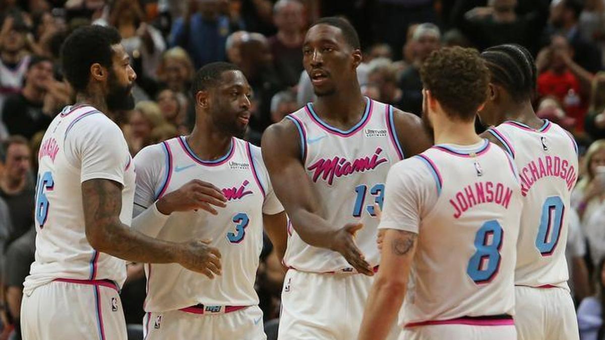 Miami Heat players James Johnson (16), Bam Adebayo (13), Tyler Johnson (8) and Josh Richardson (0) congratulate Dwyane Wade after defeating the Milwaukee Bucks 91-85 in a NBA basketball game at the AmericanAirlines Arena in Miami on Friday, February 9, 2018.