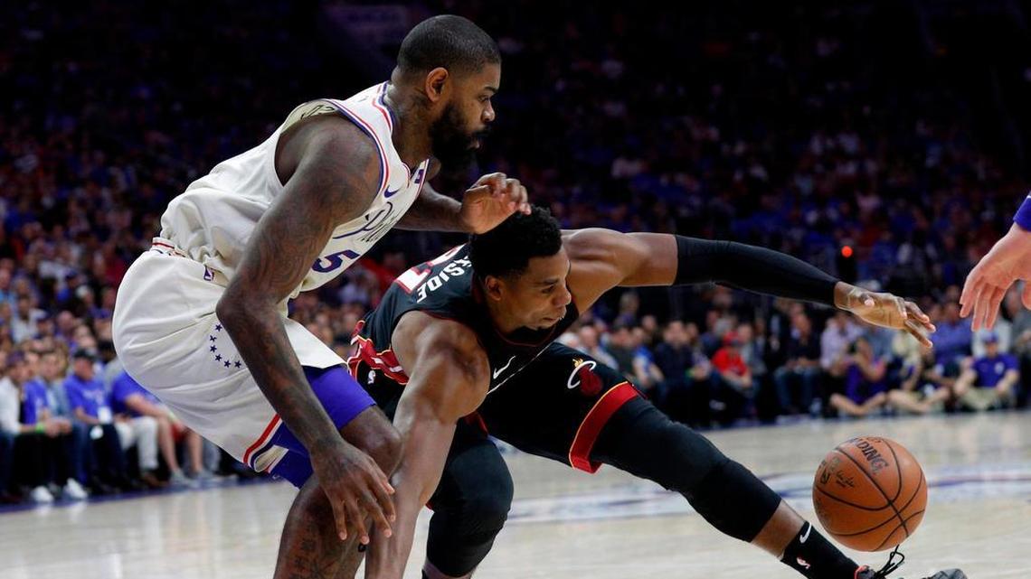 Miami Heat's Hassan Whiteside, right, reaches for the ball while Philadelphia 76ers' Amir Johnson, left, defends during the first half in Game 1 of a first-round NBA basketball playoff series Saturday, April 14, 2018, in Philadelphia. (AP Photo/Chris Szagola)