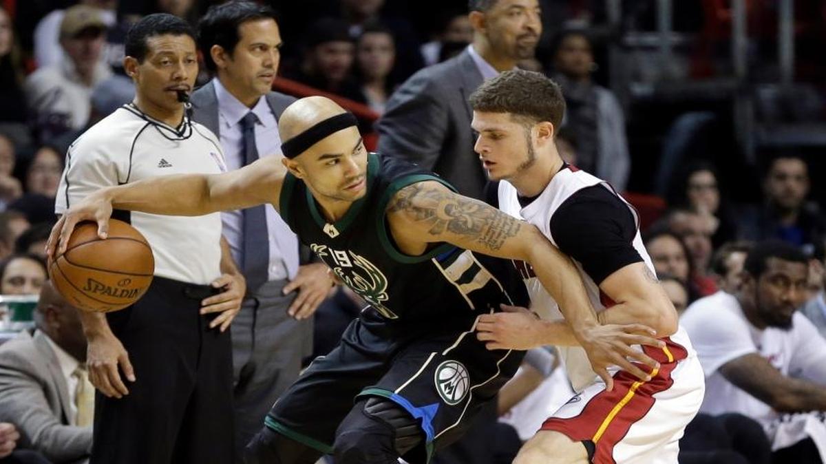 Milwaukee Bucks guard Jerryd Bayless (19) drives as Miami Heat guard Tyler Johnson (8) defends during the second half Tuesday, Jan. 19, 2016, in Miami. The Bucks won 91-79.