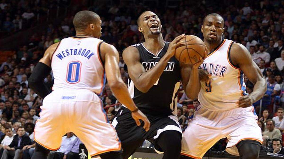 
Chris Bosh drives to the basket against Russell Westbrook and Serge Ibaka in the first quarter of the Miami Heat’s game against the Oklahoma City Thunder at AmericanAirlines Arena in Miami on Tuesday, January 20, 2015.

