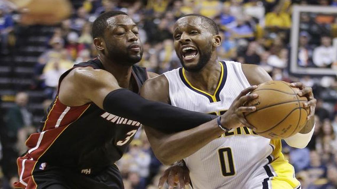 
Indiana Pacers' C.J. Miles (0) is fouled by Miami Heat's Dwyane Wade (3) during the second half of an NBA basketball game Wednesday, Dec. 31, 2014, in Indianapolis. The Pacers defeated the Heat 106-95. 
