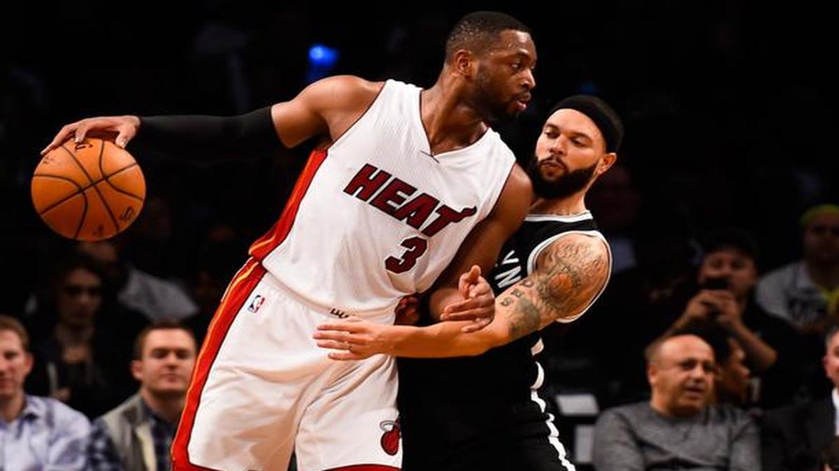 
Deron Williams #8 of the Brooklyn Nets guards Dwyane Wade #3 of the Miami Heat in the second half at the Barclays Center on December 16, 2014 in the Brooklyn Borough of New York City.
