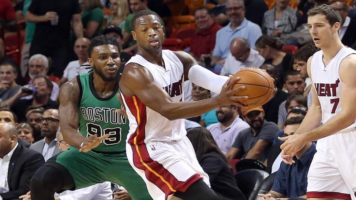 Dwyane Wade of the Miami Heat gets the ball from Gorian Dragic as he avoids Jae Crowder of the Boston Celtics in the first quarter at AmericanAirlines Arena in Miami on Monday, November 30, 2015.