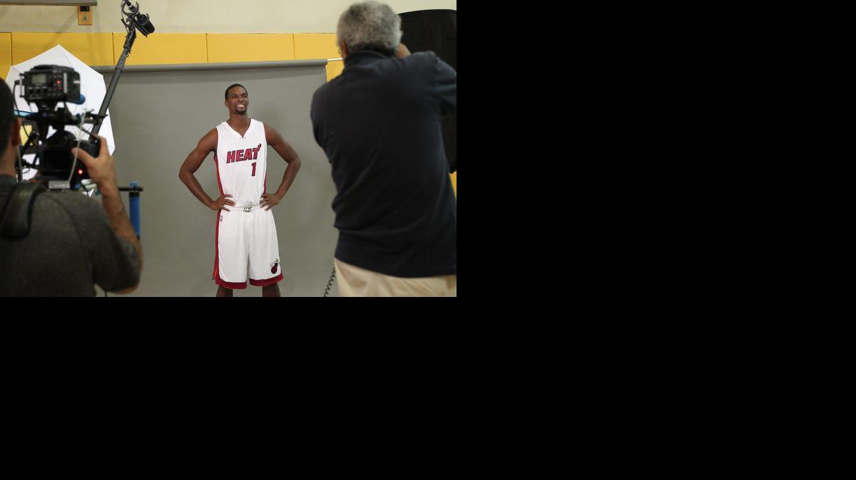 
The Miami Heat's Chris Bosh poses for photographers during the team's Media Day at AmericanAirlines Arena in Miami on Friday, Sept. 26, 2014.
