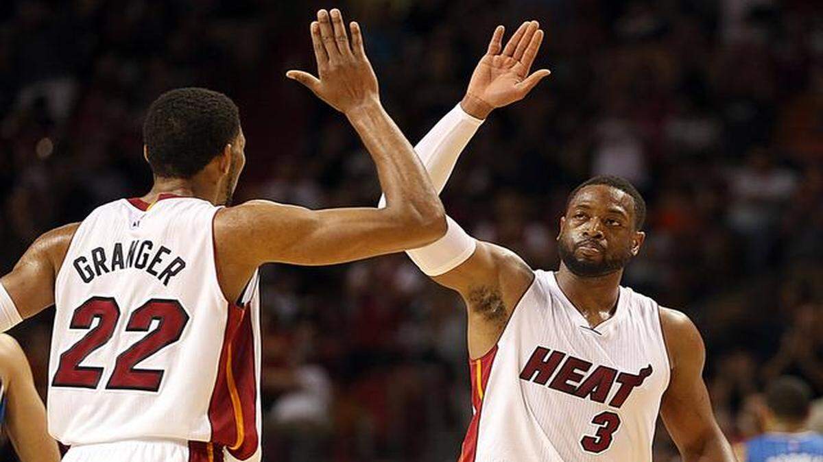 
Miami Heat guard Dwyane Wade, here shown high-fiving teammate Danny Granger during a game against the Orlando Magic on Dec. 29, 2014, returned to Miami Saturday, Jan. 17, 2015, hobbled, but excited about the remainder of the Heat’s season after the team finished its five-game road trip 3-2.
