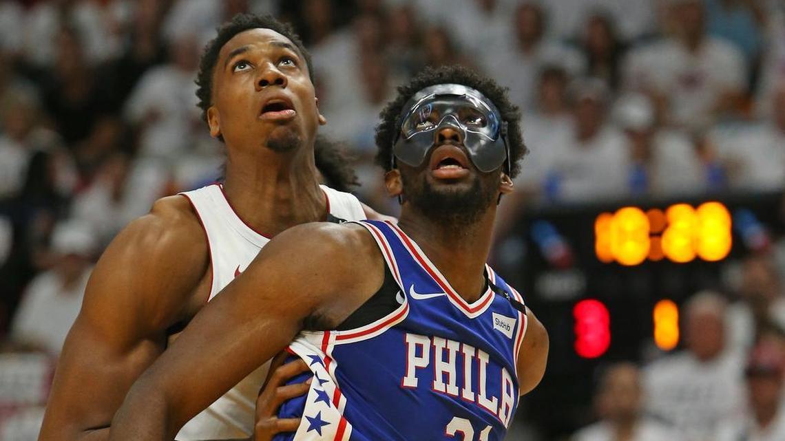Miami Heat center Hassan Whiteside fights for position under the basket against Philadelphia 76ers center Joel Embiid during the first quarter of Game 3 of the first-round NBA basketball playoff series at AmericanAirlines Arena in Miami on Thursday, April 19, 2018.