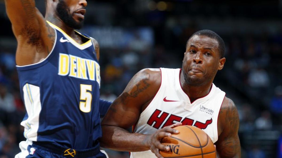Miami Heat guard Dion Waiters, right, drives the lane as Denver Nuggets guard Will Barton defends during the first half of an NBA basketball game Friday, Nov. 3, 2017, in Denver.