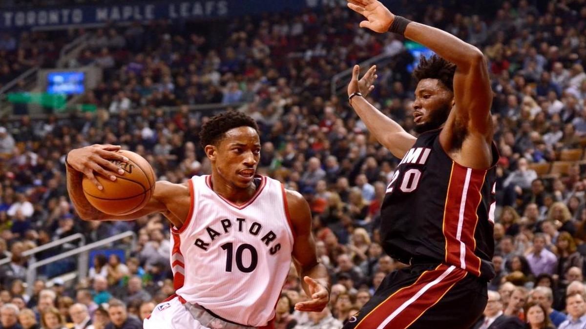 Toronto Raptors' DeMar DeRozan, left, drives to the net around Miami Heat's Justise Winslow during the first half of an NBA basketball game Fri., Nov. 4, 2016, in Toronto.