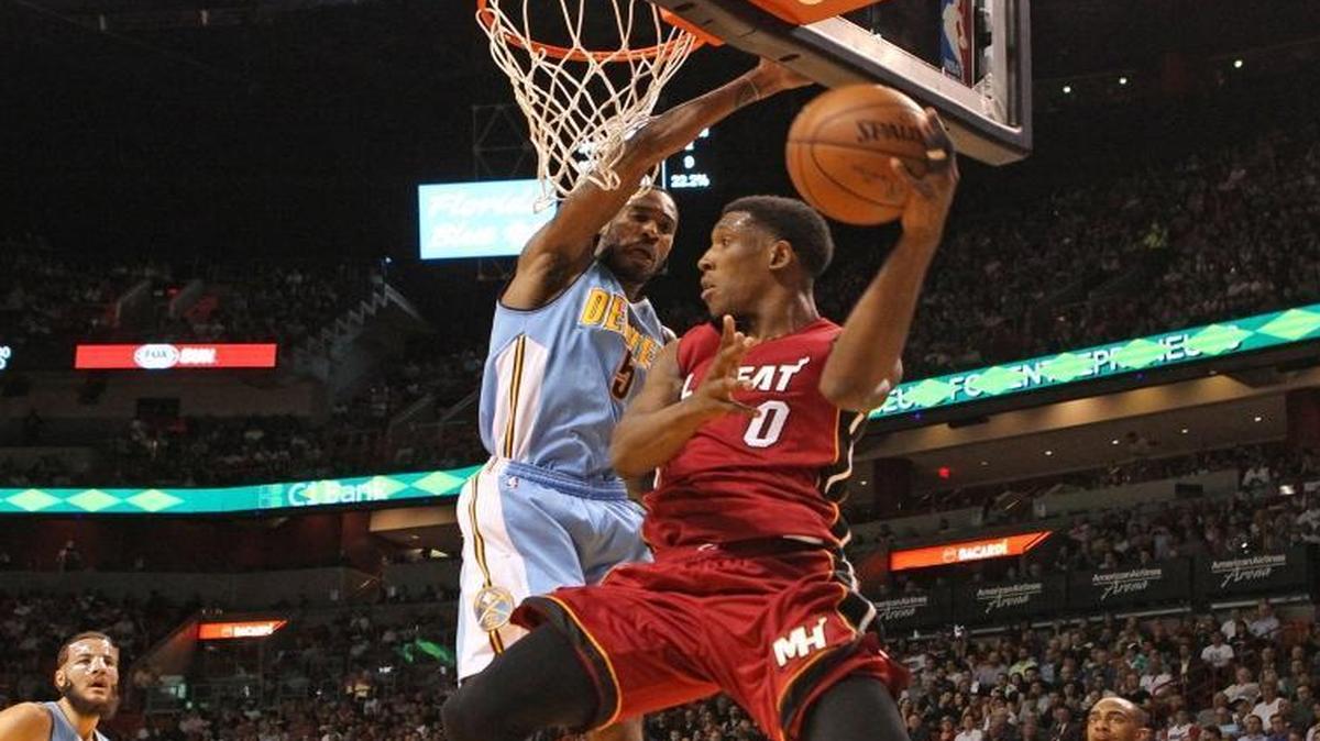 Josh Richardson looks to pass the ball as Will Barton defends during the first quarter of the Miami Heat’s game against the Denver Nuggets at AmericanAirlines Arena in Miami on Monday, March 14, 2016.