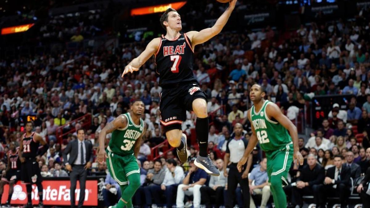 Miami Heat's Goran Dragic (7) goes to the basket over Boston Celtics' Marcus Smart (36) and Al Horford (42) on Wednesday, Nov. 22, 2017, in Miami. The Heat won 104-98.