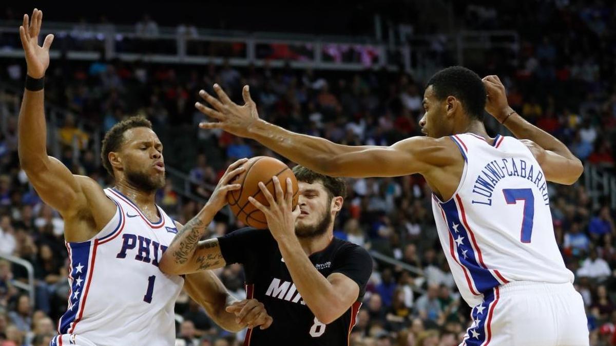 Philadelphia 76ers' guards Justin Anderson (1) and Timothe Luwawu-Cabarrot (7) defend Miami Heat guard Tyler Johnson (8) during the second quarter of an NBA preseason basketball game in Kansas City, Mo., Fri., Oct. 13, 2017.