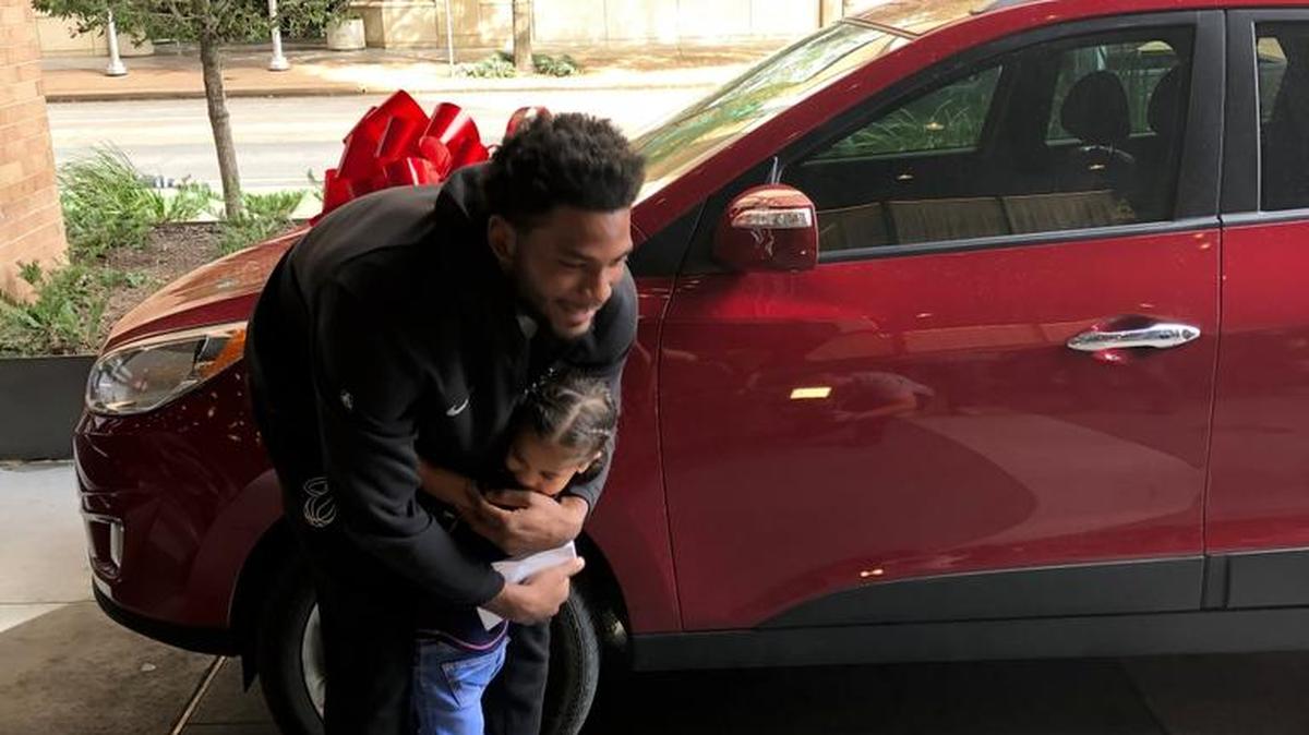Justise Winslow gets a grateful hug on Sunday in his hometown of Houston from one of the youngest members of a Houston-area family that was affected by Hurricane Harvey. Winslow donated $50,000 to a pair of families - that he met with Sunday afternoon - to help them purchase cars to help ease transportation difficulties caused by the storm.