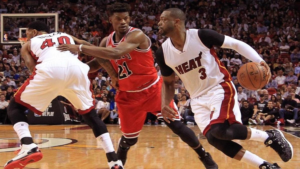 Dwyane Wade uses a screen from teammate Udonis Haslem to get past Jimmy Butler during the Miami Heat’s game against the Chicago Bulls on Thursday, April 7, 2016 at AmericanAirlines Arena in Miami.