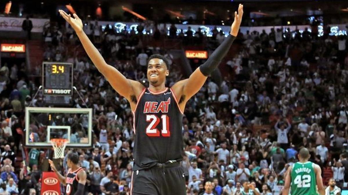 The Miami Heat's Hassan Whiteside (21) celebrates after a 104-98 win against the Boston Celtics at the AmericanAirlines Arena in Miami on Wednesday, Nov. 22, 2017. He’s now out for at least a week with a knee injury. (Al Diaz/Miami Herald/TNS)