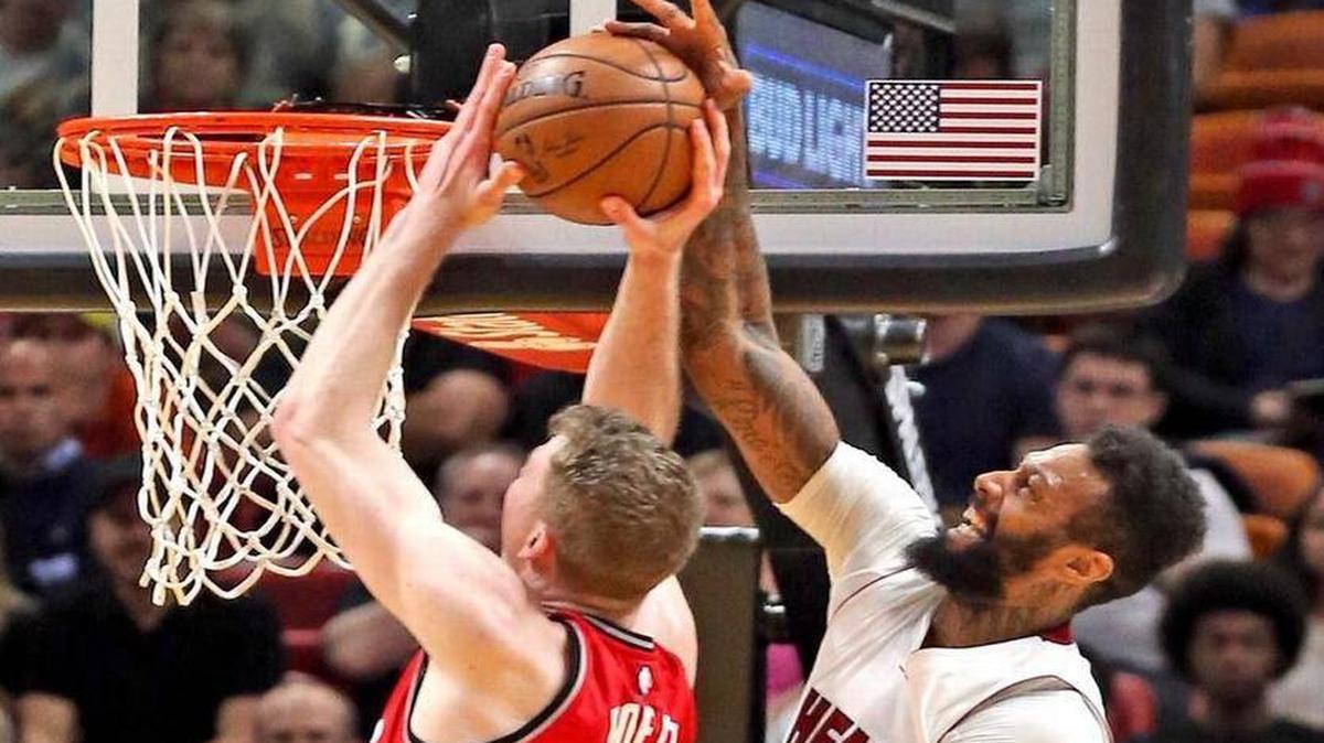 The Heat’s James Johnson denies the Raptors’ Jakob Poeltl during the second quarter of a March 23rd game at AmericanAirliness Arena.