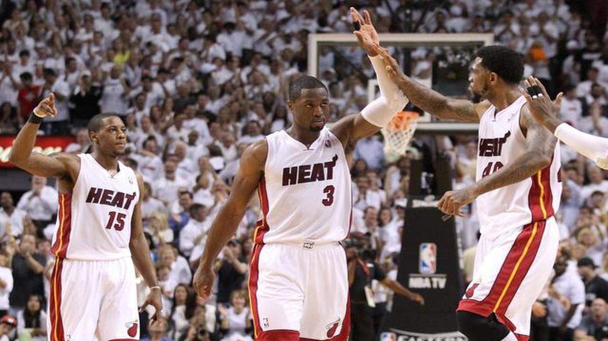 
Three the hard way: From left, Mario Chalmers, Dwyane Wade and Udonis Haslem have been through boon and bust cycles with the Heat, playing through rebuilding efforts and title runs.
