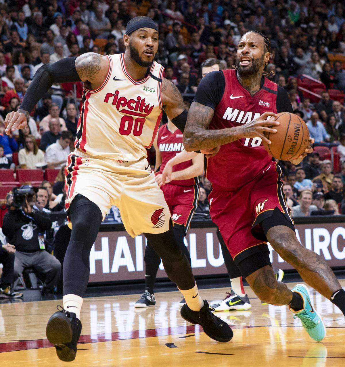 Miami Heat power forward James Johnson (16) drives past Portland Trail Blazers power forward Carmelo Anthony (00) during the second quarter of a game at AmericanAirlines Arena in Miami, Florida, on Sunday, January 5, 2020.