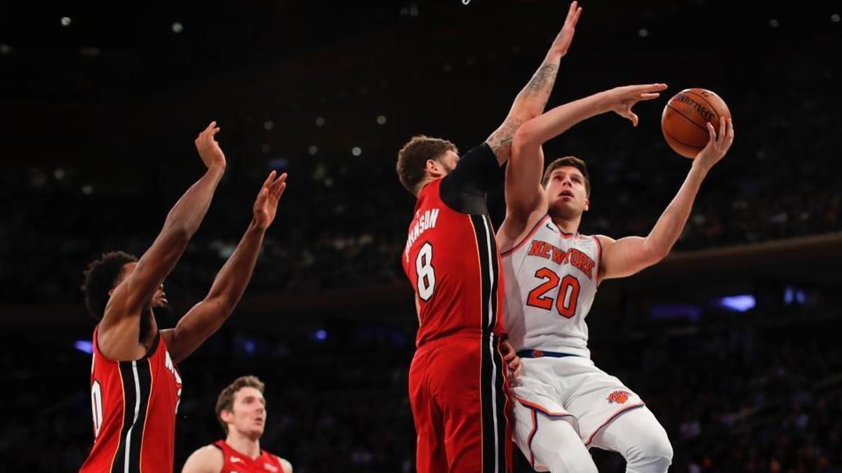 New York Knicks forward Doug McDermott (20) puts up a shot against Miami Heat guard Tyler Johnson (8) during the fourth quarter of an NBA game on Wednesday, Nov. 29, 2017, in New York. The Knicks won 115-86.