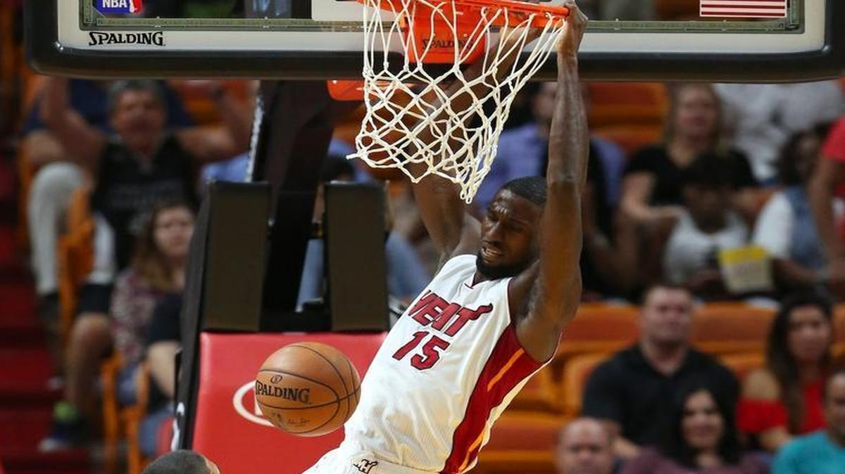Miami Heat forward Okaro White dunks against the Orlando Magic guard Nick Johnson in the fourth quarter of an preseason NBA basketball game at AmericanAirlines Arena on Tuesday, Oct. 18, 2016, in Miami.