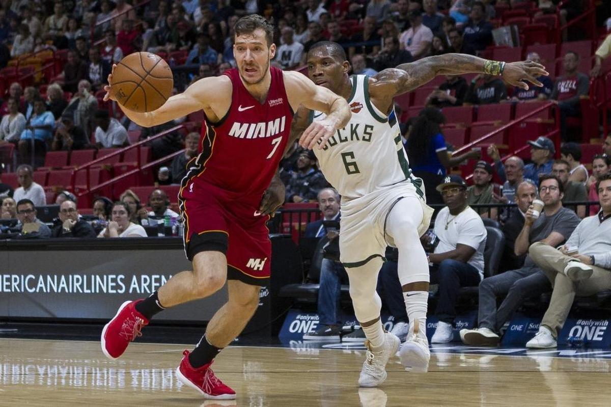 Miami Heat guard Goran Dragic (7) fights for possession against the Milwaukee Bucks’ Eric Bledsoe (6) in the first quarter as the Heat host at AmericanAirlines Arena on Sunday, Jan. 14, 2018.