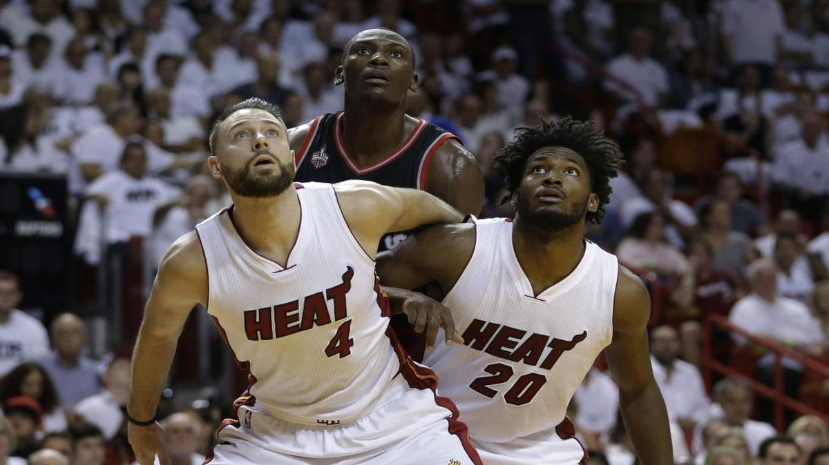 Miami Heat forward Josh McRoberts (4) and Miami Heat forward Justise Winslow (20) blocks Toronto Raptors center Bismack Biyombo (8) during a free throw, in Game 4 of an NBA second-round playoff basketball series, Mon., May 9, 2016, in Miami.