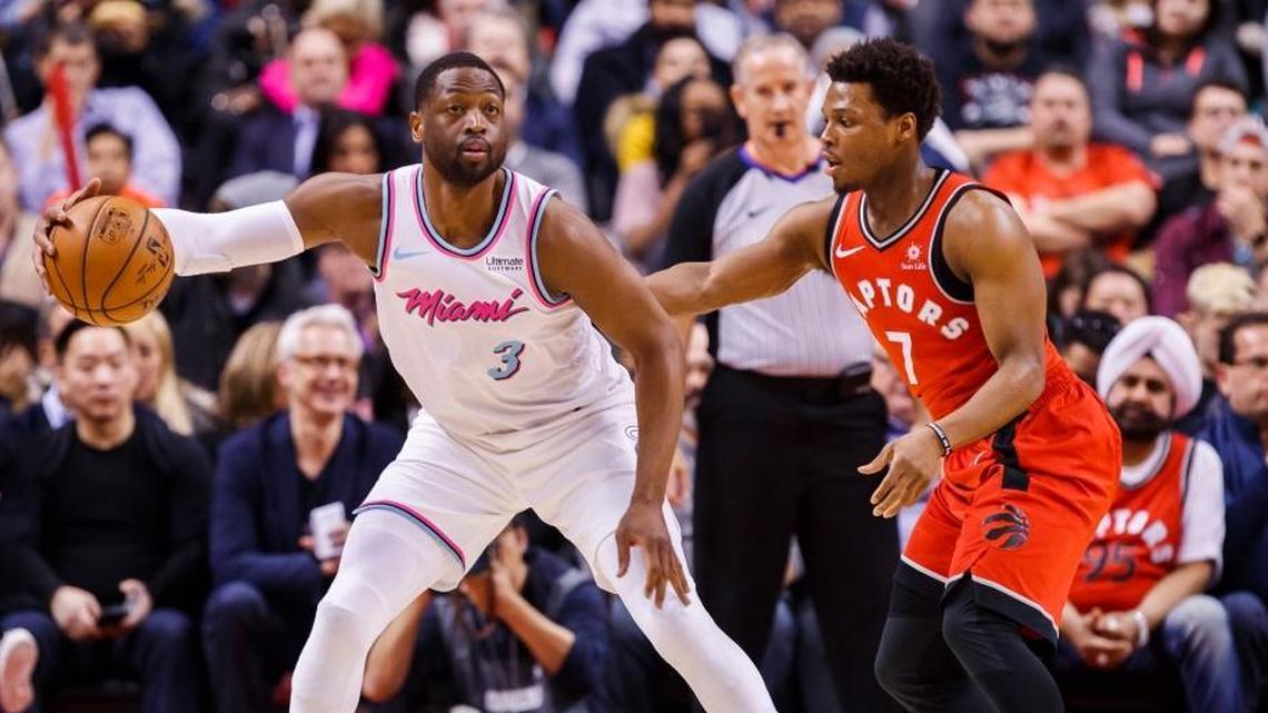 Miami Heat guard Dwyane Wade is guarded by Toronto Raptors’ guard Kyle Lowry, right, during the first half of an NBA basketball game on Feb. 13, 2018, in Toronto.