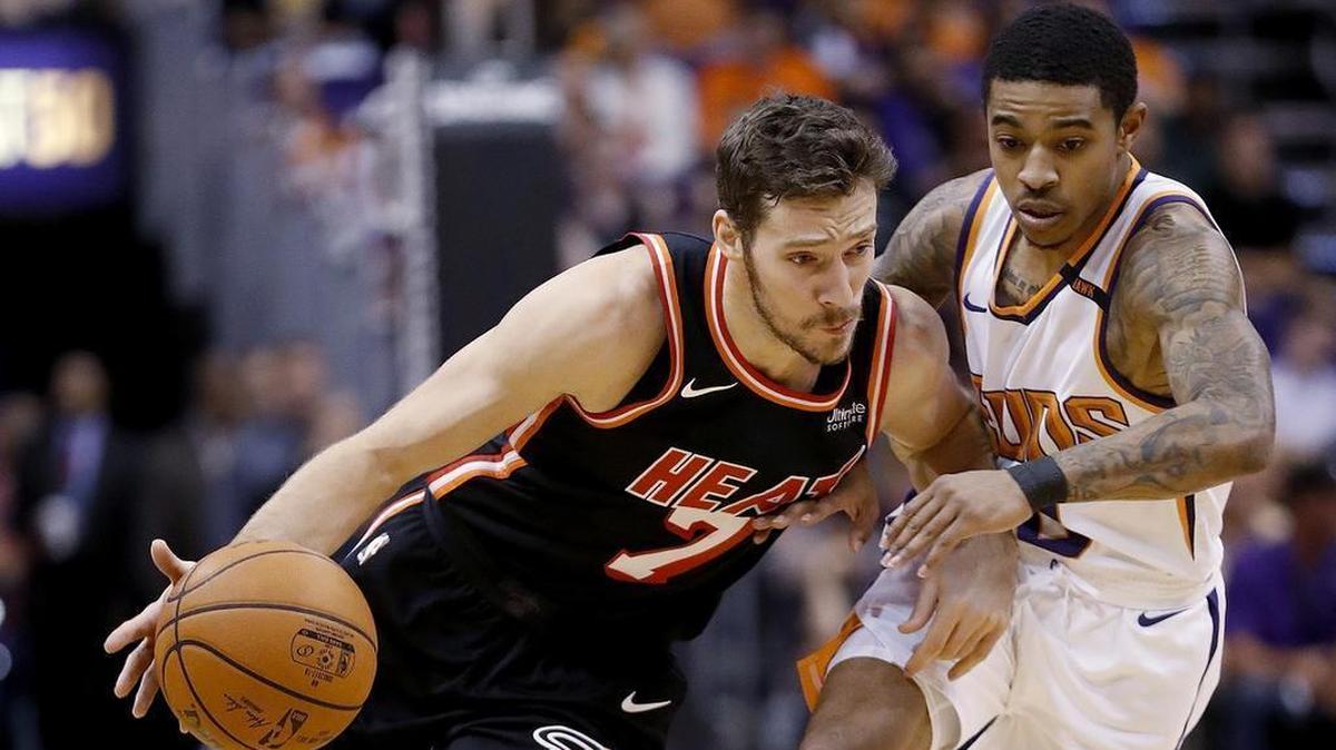 Miami Heat guard Goran Dragic drives around Phoenix Suns guard Tyler Ulis during the first half of an NBA basketball game, Wednesday, Nov. 8, 2017, in Phoenix.
