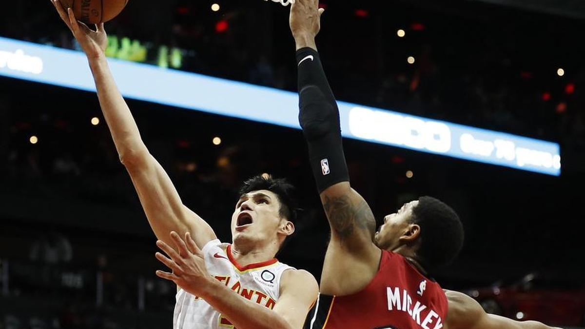 Atlanta Hawks' Ersan Ilyasova, left, of Turkey, shoots against Miami Heat's Jordan Mickey in the second quarter of an NBA basketball game in Atlanta on Monday, Dec. 18, 2017. Mickey, 23, is proving his worth off the bench during a rough stretch of injuries to key Heat players.