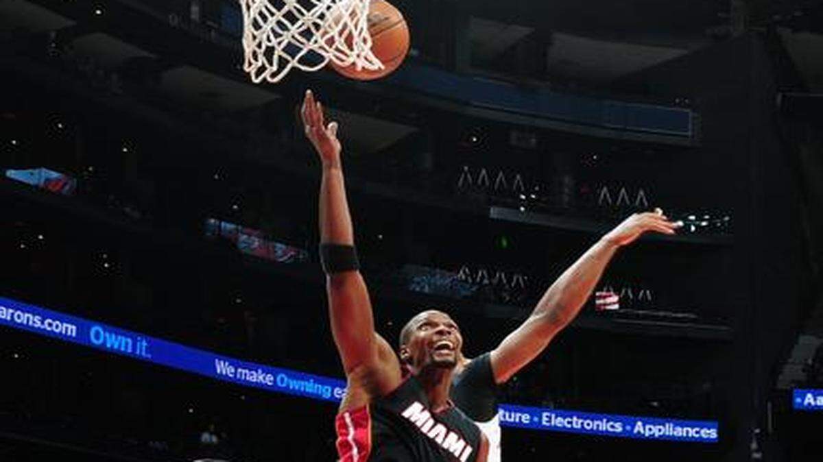 
Miami's Chris Bosh (1) grabs a rebound against the Atlanta Hawks in Friday’s 114-103 loss.
